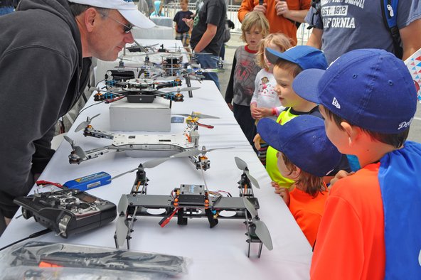 Kids looking at drones at Maker Faire