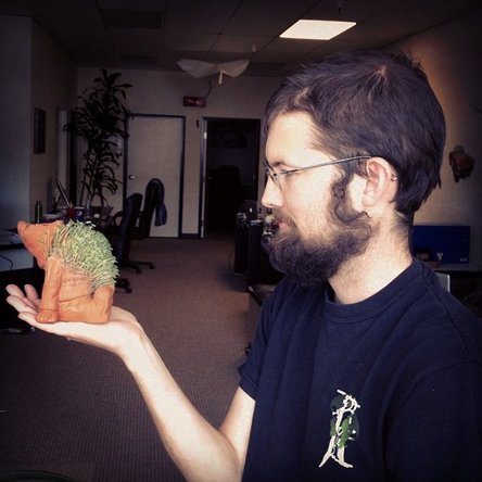 iFixit co-founder Luke holding a garden gnome