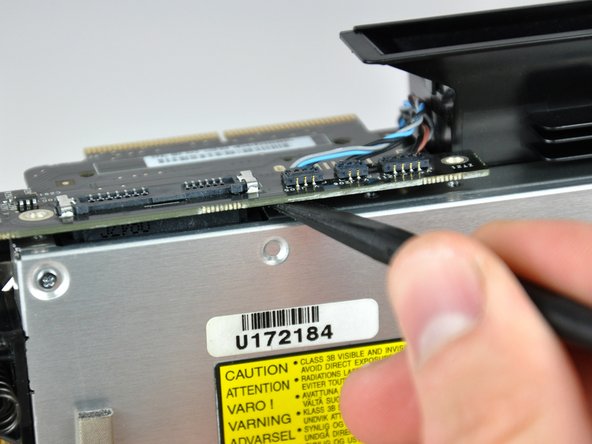 Image 1/1: Carefully increase the crevice to disconnect the optical drive from the interconnect board.
