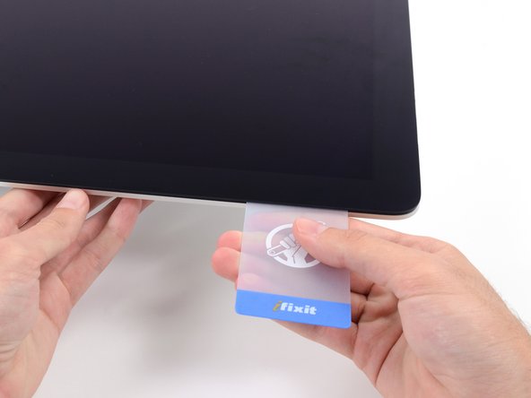 Image 1/2: As with the other side, twist slowly to allow the adhesive time to separate, and be careful not to over-stress the display glass.