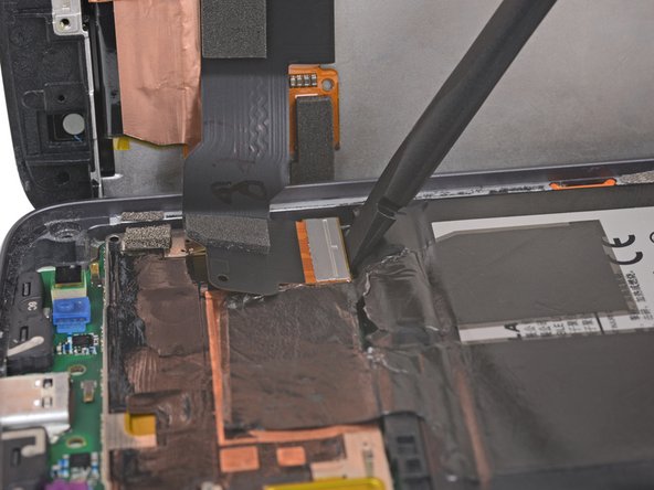 Use the flat end of a spudger to lift the display cable connector up out of its socket.