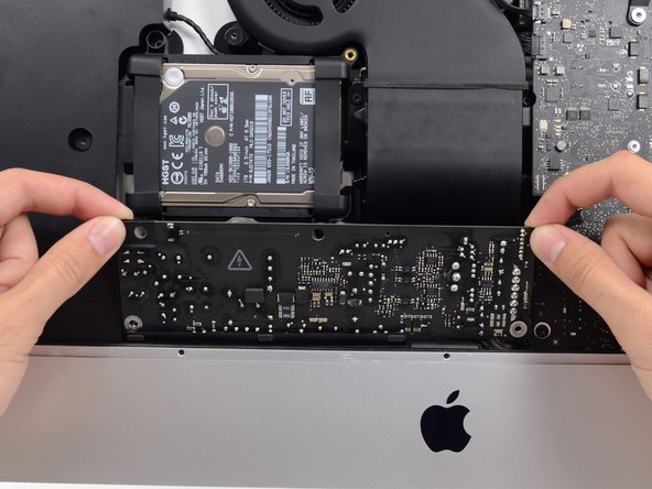 Image 2/2: Tilt the power supply forward.