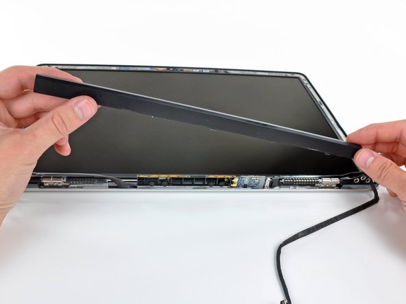 Image 2/2: Lift the clutch cover up off the front bezel and set it aside.