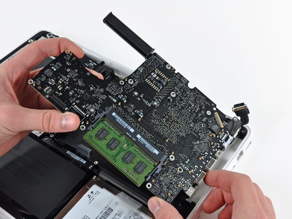 Image 2/3: Pull the logic board and MagSafe board away from the edge of the upper case as one piece.