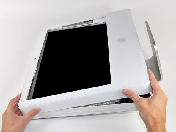 Image 1/1: Lift the front bezel from its lower edge and rotate it away from the rest of your iMac, minding the RAM arms that may get caught.