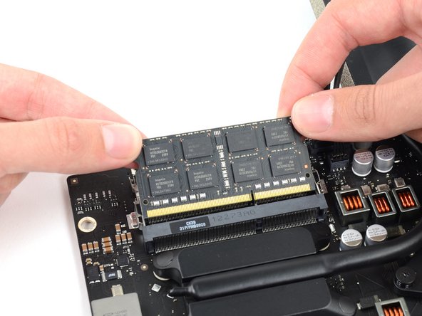 Image 3/3: Repeat the process to remove additional RAM modules as necessary.