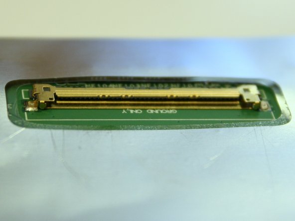 Image 2/3: A protective sheet is taped to the front of the display. Leave it on until we are almost done installing the display in the laptop.