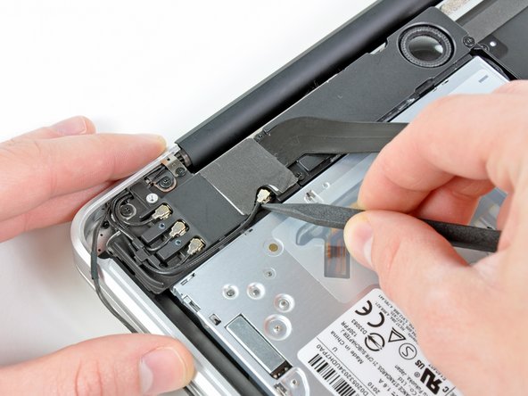 Image 2/3: De-route each of the cables from their channels in the AirPort/Bluetooth bracket.