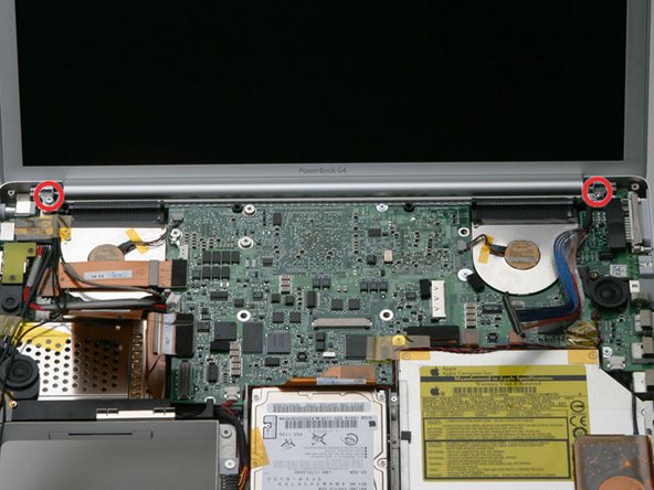 Image 1/1: Remove the T8 Torx screw closer to the display on either side of the hinge (two screws total).