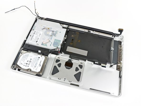 Image 1/3: Small plastic plates adhered near the display hinges seem to keep the display data cable and antenna cable bundle stationary while the display is opened and closed.