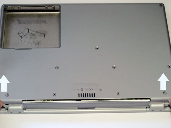 Image 1/1: The lower case may stick in the front on a tab just above the center of the DVD drive. Be careful as you work the case off, or you may break the thin strip of plastic just above the drive.