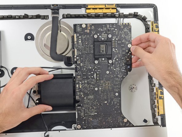 Image 2/3: Be careful not to snag the board on any of the rear case's screw posts.