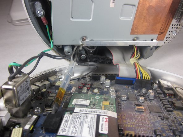 Image 2/2: A fixed plug connector between the logic board and upper unit will cause some resistance. Pull gently but firmly.