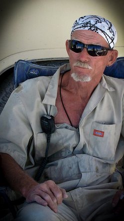 Wingman waiting at his auto repair shop at Burning Man