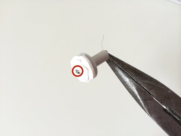 Image 1/2: Using your normal pliers and/or a fine screwdriver/knife, try to jam out a little metal part that is clipping the two wires and attaching them to the white plastic.