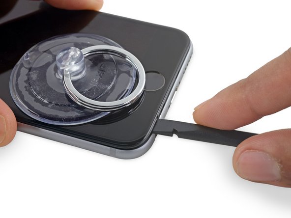 Twist the spudger to widen the gap between the front panel assembly and the rest of the phone.