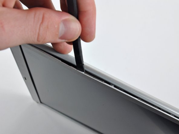 Image 2/2: Work along the right edge of the display until the rear bezel is evenly separated from the front bezel.