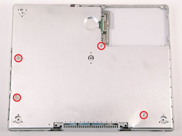 Image 1/1: The two longer screws are along the computer's edge, near the ports.