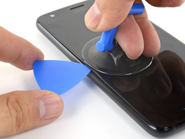 Insert the point of an opening pick into the gap.