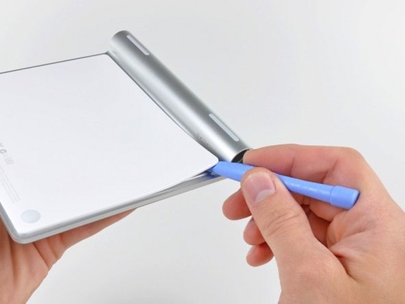 Image 1/2: Don't pry up along the bottom (the edge opposite the battery compartment). There are a bunch of retaining clips that may break if you start from the bottom.