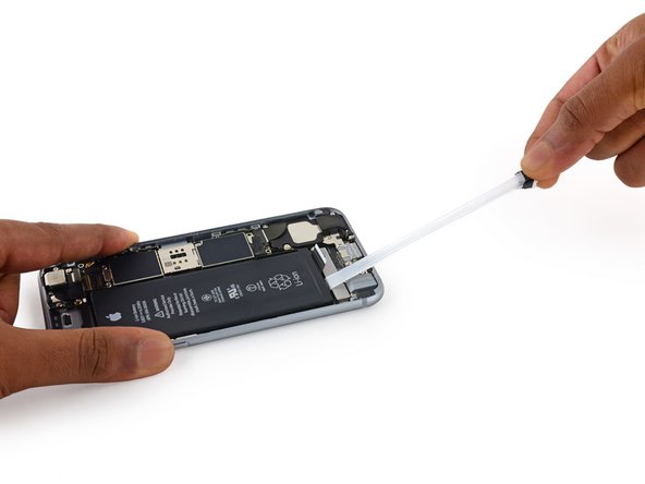 Slowly pull one battery adhesive tab away from the battery, toward the bottom of the iPhone.