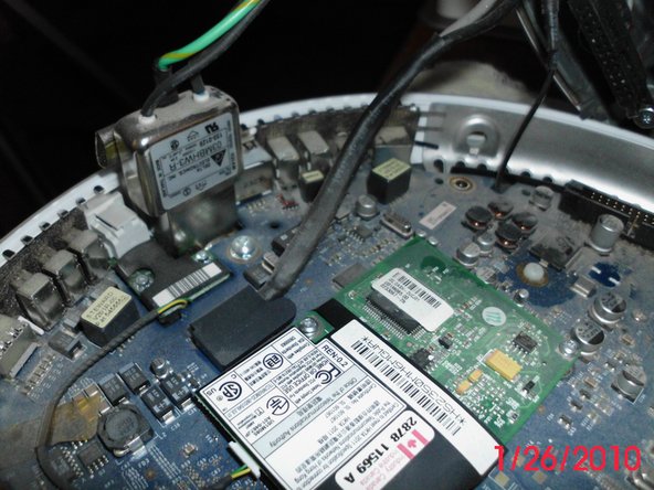 Image 2/2: Locate the 3.6 volt 1/2 AA Lithium PRAM battery on the logic board and replace it.