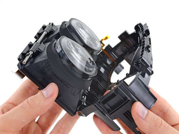 Image 2/3: This slot allows the nub to peek through and slide along that white Teflon strip, activating a linear [https://en.wikipedia.org/wiki/Potentiometer|potentiometer], used to track IPD position as you adjust the displays.