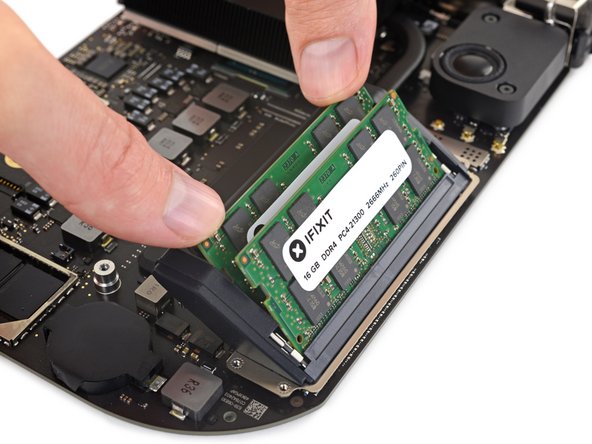 Finally, press the top edge of each RAM module to swing it down toward the logic board until the retaining clips on each side snap into place.