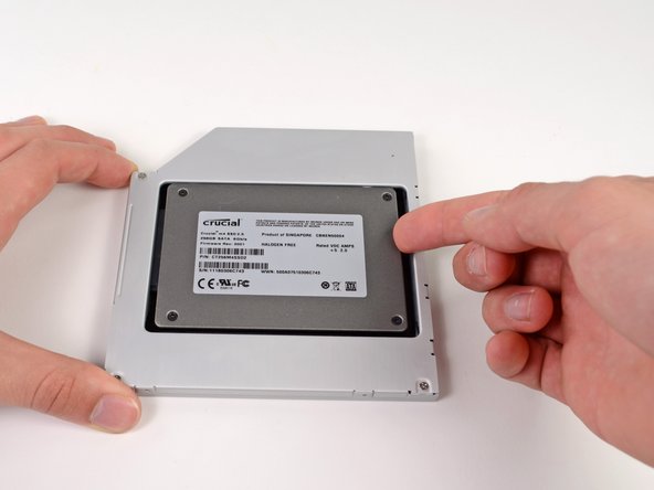 Image 3/3: While firmly holding the enclosure in place with one hand, use your other hand to press the hard drive into the enclosure connectors.