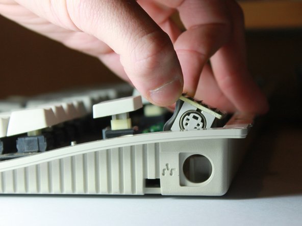 Image 3/3: When it's possible, grab the top of the green PCB and lift the board out of it's small mount.