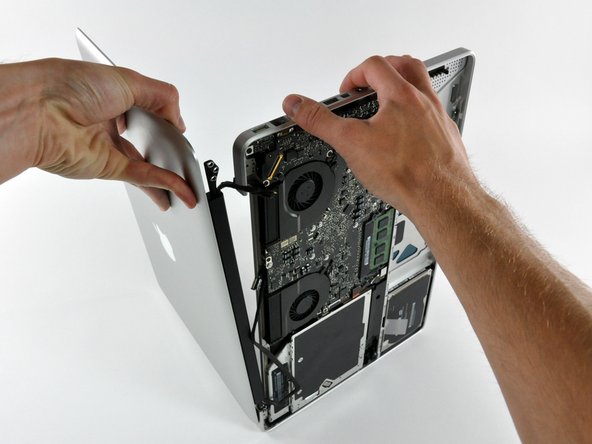 Image 3/3: Lift the display away from the upper case, minding any brackets or cables that may get caught.