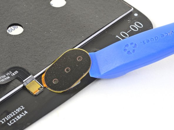 Use an opening tool to pry up and loosen the fingerprint sensor from the screen.