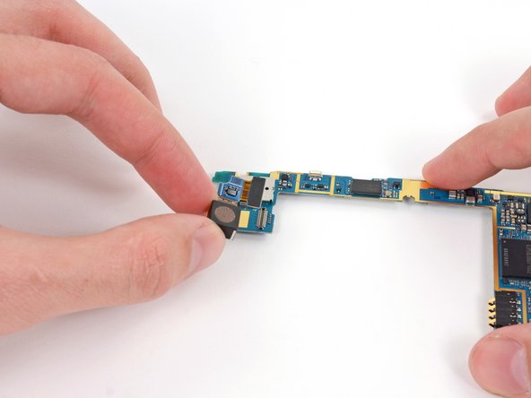 Image 1/1: Remove the rear-facing camera off the motherboard.