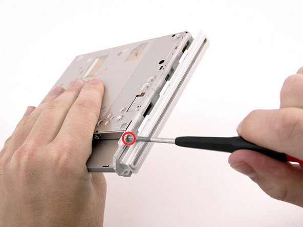 Image 1/1: This screw is longer than the two that secure the bracket and cable at the back of the drive.