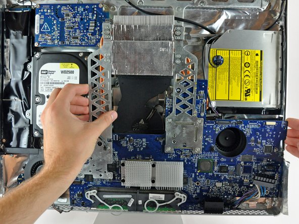 Image 1/1: Pull the right edge of the logic board toward yourself slightly to free the I/O ports from the rear case, being careful not to bend the board.