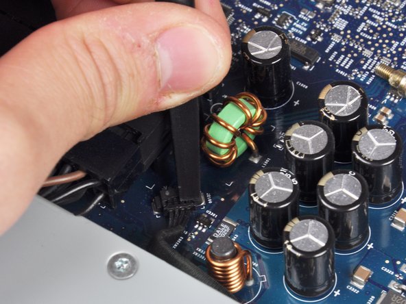 Image 3/3: Your power supply may have an ambient light sensor cable attached from the power supply to the logic board. If so, carefully use a spudger to push out the cable towards you using the sides of the cable alternatively to help you slide it out.