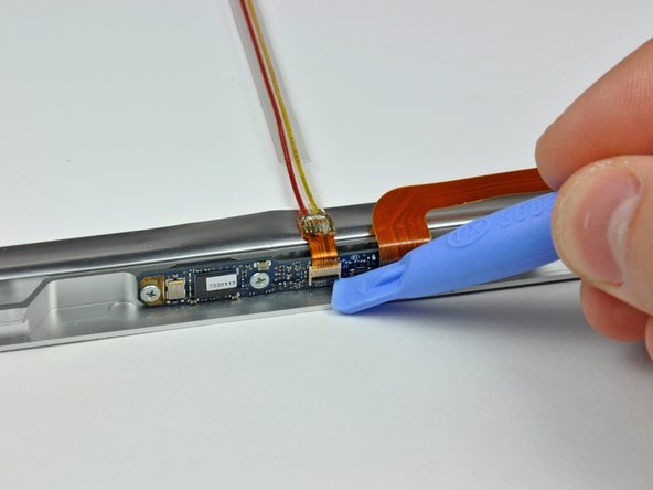 Image 2/3: Pull the camera cable out of its socket.