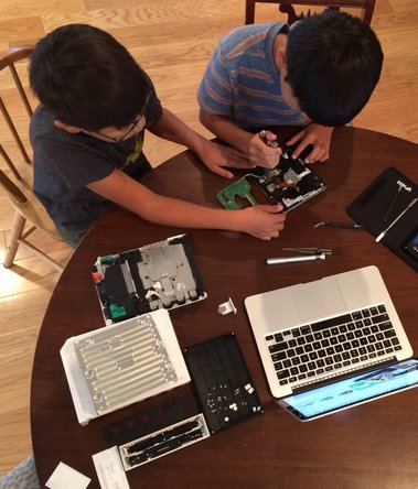 kids fixing Wii with help from their father