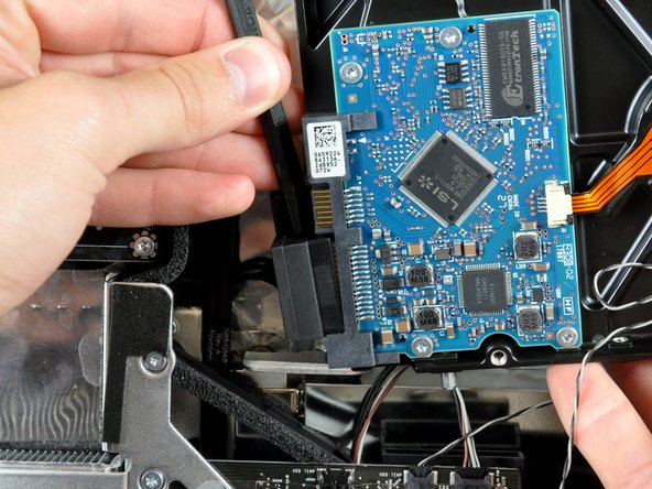 Twist the spudger to separate the SATA data cable from the hard drive.