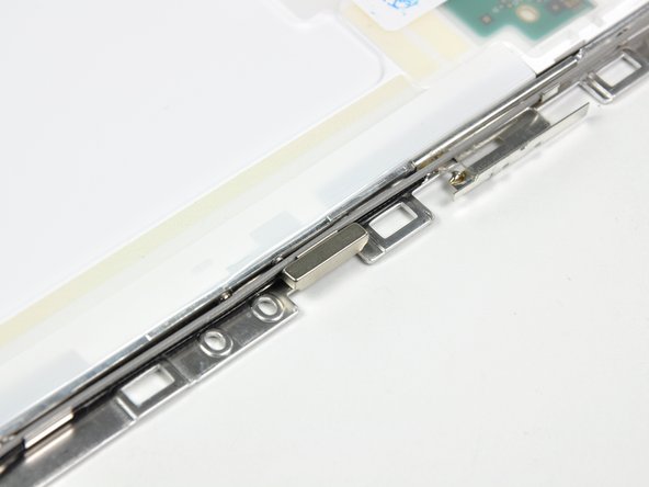 Be sure to keep track of the small magnet along the left side of the display. It may be stuck to the LCD frames or to the rear display bezel. When installing it, be sure short side is facing upward.