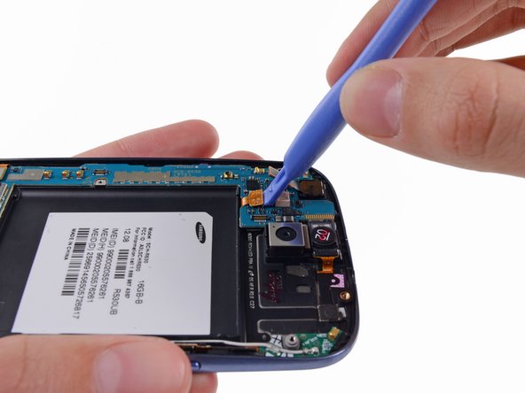Image 1/2: Disconnect the digitizer cable by gently prying its connector up from its socket on the motherboard.