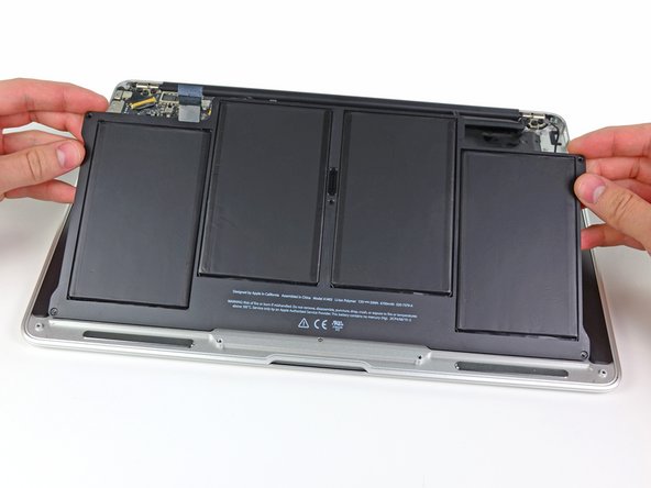 Image 1/1: Lift the battery from its edge nearest the logic board and remove it from the upper case.