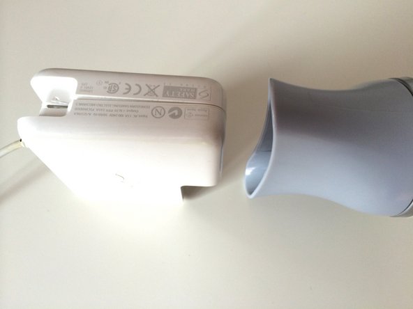 Image 1/2: Gently pull the two halves of the case apart.