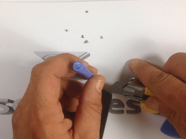 With a cutter, make a room for a plastic tool, then continue with separating the Touchscreen &amp; LCD Display from the frame.