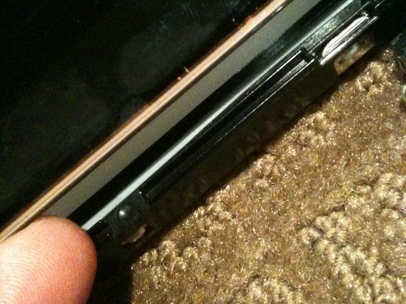 Image 2/2: Once the LCD is loose you need to HOLD it in place in the black plastic frame and '''GENTLY''' flip the entire assembly so the LCD is flat on the work surface