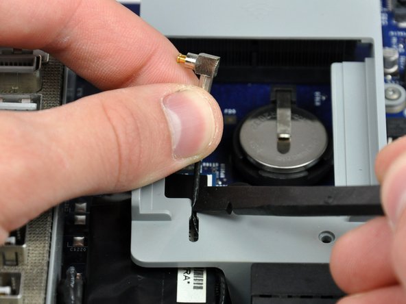 Image 1/2: De-route the AirPort antenna out from under the AirPort bracket.