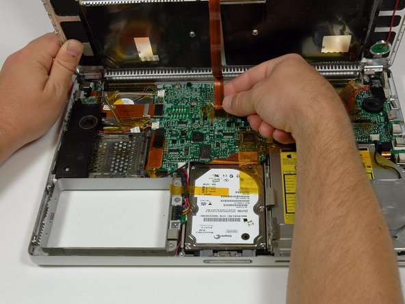 Image 1/1: Disconnect the trackpad ribbon from the logic board by pulling up on the connector.