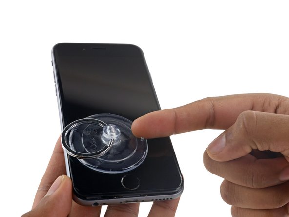 Pull up on the nub on the top side of the suction cup to remove it from the front panel.