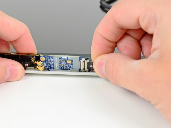 Image 1/1: When reattaching the AirPort Cable, make sure that the U-shaped notches on one side of the cable end are not visible (facing the card). If the cable is installed incorrectly, it will cause logic board damage.
