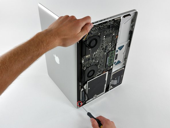 Image 1/1: Place your opened MacBook Pro on a table as pictured.